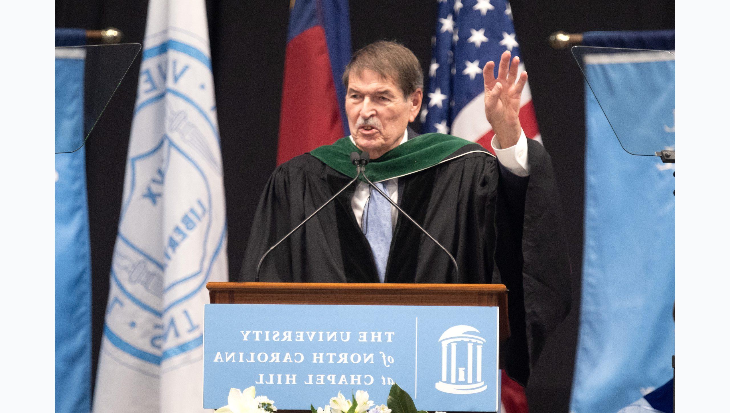 Dr. Shelley Earp speaking from a podium at U.N.C. Chapel Hill's Winter Commencement